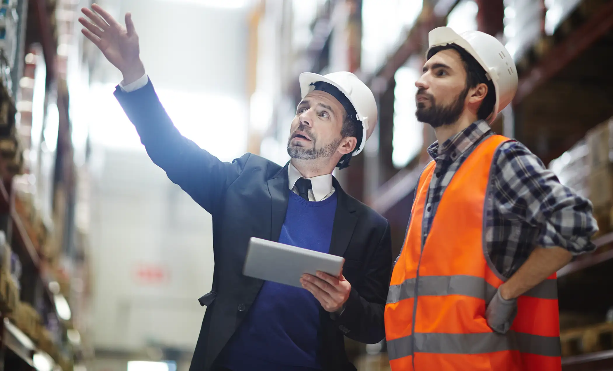 warehouse workers looking at product on a shelf